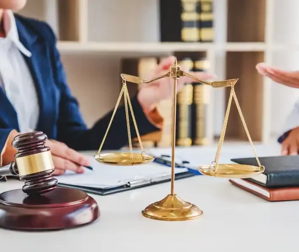 scales-of-justice-gavel-on-desk-lawyers-discussing-2026-01-07-01-44-54-utc 1